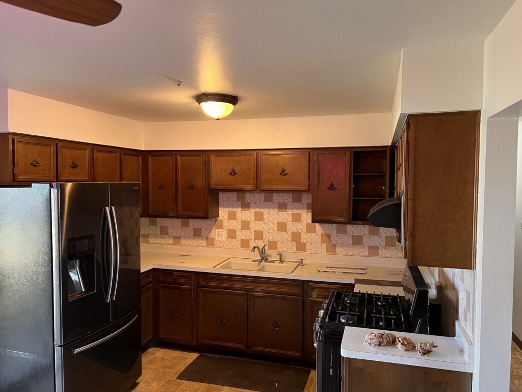 Kitchen with wood cabinets and tile backsplash
